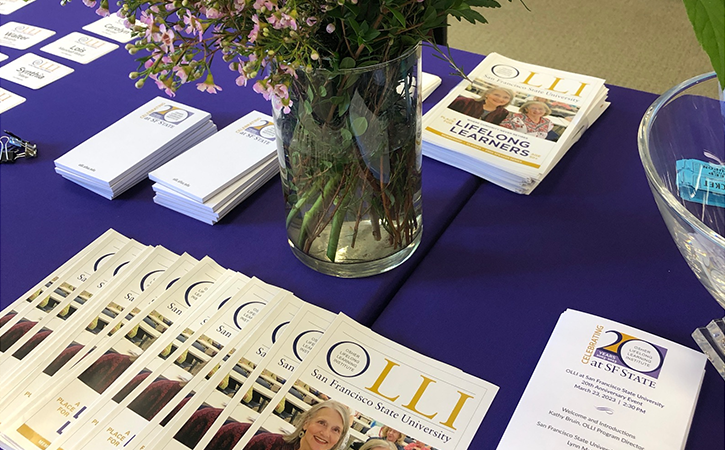 Table with OLLI brochures and flowers