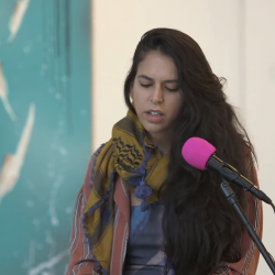 Zaina Alsous talking at the podium
