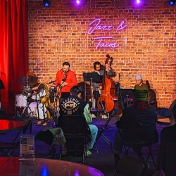 The Jazz & Tacos stage, with a clarinet player and a cello player onstage.